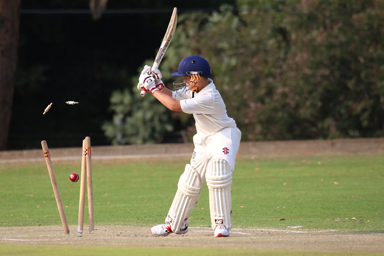 Pro Cricket Kit Young cricket player in focused action on the field. Capturing the moment of impact.